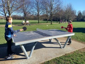 Two boys playing table tennis on the new permanent table tennis table in Millennium Park in Nailsea